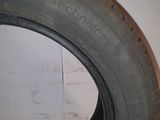 a close up of a tire on a wooden floor with a white wall in the background