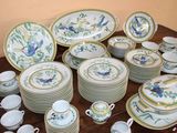 a lot of plates and cups on the table