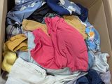a cardboard box filled with clothes and other items