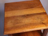 a small wooden table with a shelf on it