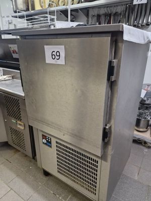 a stainless steel refrigerator in a kitchen with a price tag on it