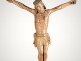a wooden statue of jesus on the cross on a white background