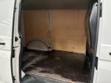 a white van with the door open and a cat bed in the back of the van