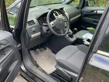 the interior of a car with the door open and the driver ' s seat down