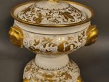 an image of a white and gold covered bowl on a stand