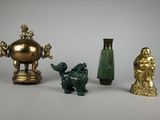 three different types of vases and statues on the table
