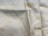 a close up of a blue and white striped towel on a bed