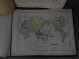 a map of the world in a book on a table