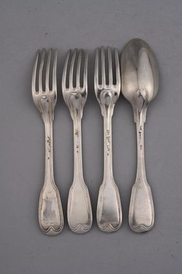 four forks and a spoon are lined up on a table