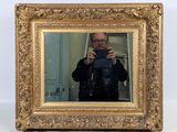 a man taking a picture of himself in a mirror