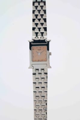 an image of a woman ' s wrist watch with a square face