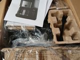 a cardboard box with a coffee maker inside of it
