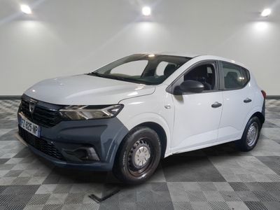 the white car is parked on a checkered floor in a room