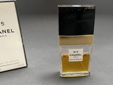 chanel no 5 perfume bottle next to a box of perfume