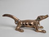 brass figurine of a dog on a white background
