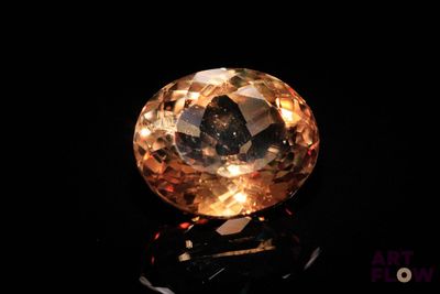 a close up of a yellow diamond on a black surface