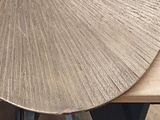 a large metal disc on a wooden table with metal legs