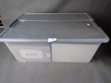 a plastic box with a lid that has a tag on it