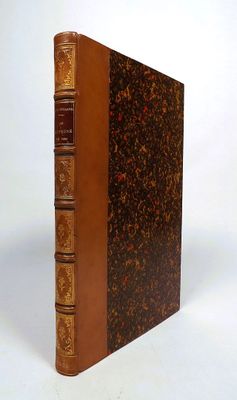 an old book sitting on top of a white table next to a white wall
