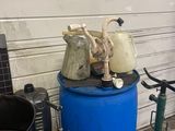 a blue barrel with a water pump on top of it next to a blue barrel with a water pump on top of it