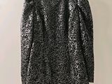 a black and white leopard print dress hanging on a hanger