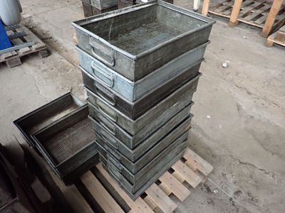 a stack of metal containers on a pallet in a warehouse