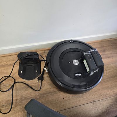an image of a roombake and a charger on a wooden floor