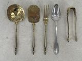 several spoons, forks and spoons are lined up on a table