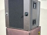 two speakers stacked on top of each other in a room