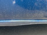 a close up of a car ' s front bumper and fender