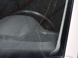 a broken window of a car with a steering wheel