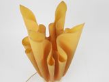 a vase that has a bunch of pieces of yellow paper in it