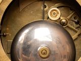 a close up of a clock with a metal ball in the center