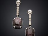 an image of a pair of earrings with diamonds on a black background