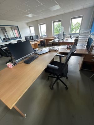 a desk with a computer and a monitor on it