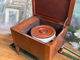 une boîte en bois munie d'un couvercle, à l'intérieur de laquelle se trouve un bol