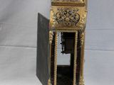 a gold clock that is sitting on a table