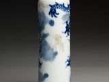 a blue and white vase with a dragon design on it