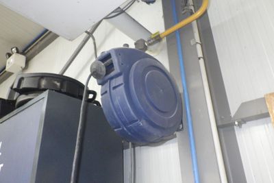 une poubelle bleue et une poubelle noire dans un garage