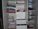 a closet with a lot of clothes in it