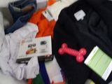 a pile of clothes and a book on a bed