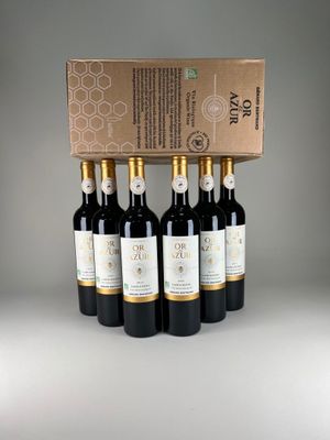 four bottles of wine in a cardboard box on a table