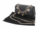 a black purse with a chain strap and a gold chain
