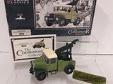 a green toy truck with a crane on top of it