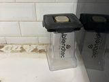 a cell phone sitting on a counter next to a trash can