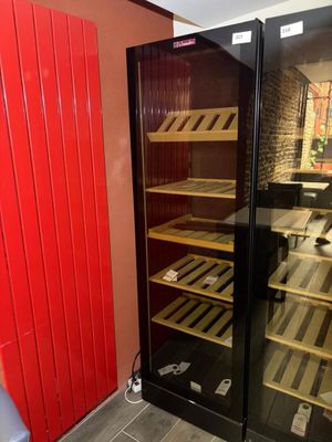 a wine cooler in the corner of a room