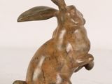 bronze sculpture of a rabbit sitting on its hind legs