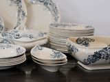 a lot of plates and bowls on the table