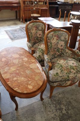 several chairs and a table in a room with a lot of furniture