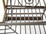 a metal shelf that has a bird cage on it